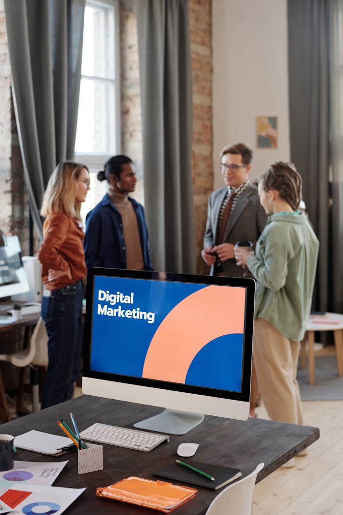 why-choose-us Business team engaged in a digital marketing discussion in a modern office setting.